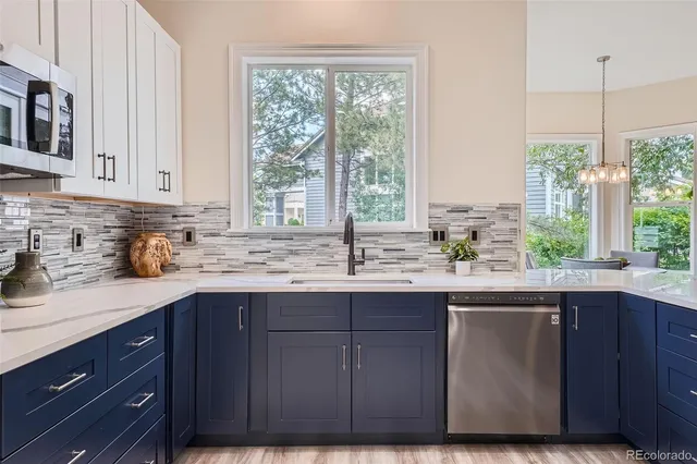 a kitchen with a sink window and cabinets