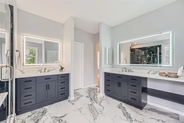 a spacious bathroom with a granite countertop double vanity sink mirror and