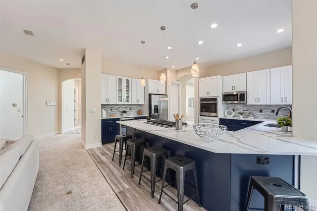 a large kitchen with stainless steel appliances lots of counter space and breakfast area