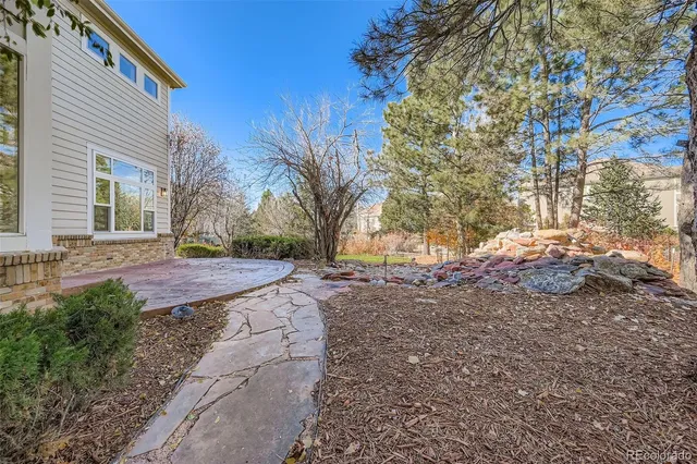 a front view of a house with a yard and a garden