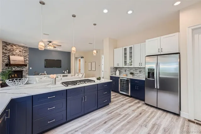 a large kitchen with stainless steel appliances and wooden cabinets