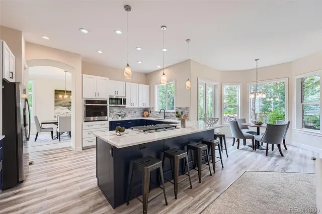 a kitchen with kitchen island a sink stove and a refrigerator