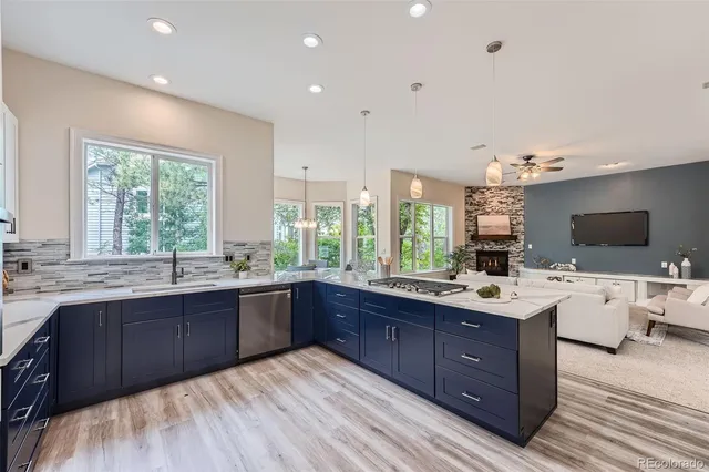 a large kitchen with wooden cabinets and sink