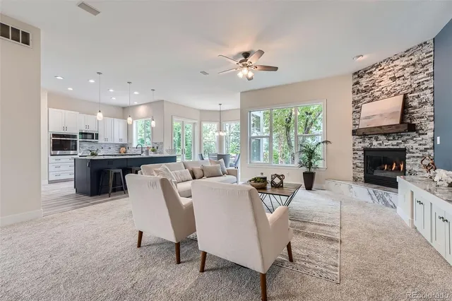 a living room with furniture a fireplace and a flat screen tv