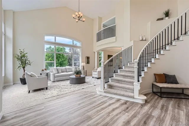 a living room with wooden floor and furniture