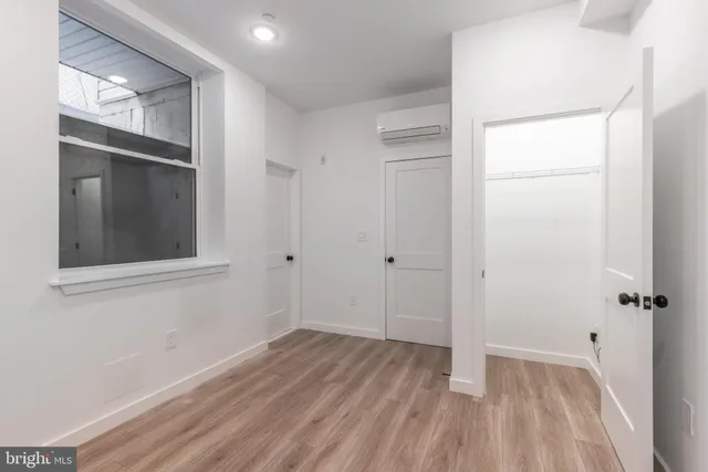 a kitchen with a refrigerator a stove top oven a sink and dishwasher with wooden floor