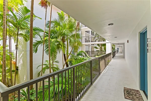 a view of balcony with wooden floor and fence
