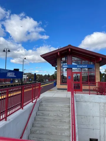 a view of a roof deck with couches and wooden floor