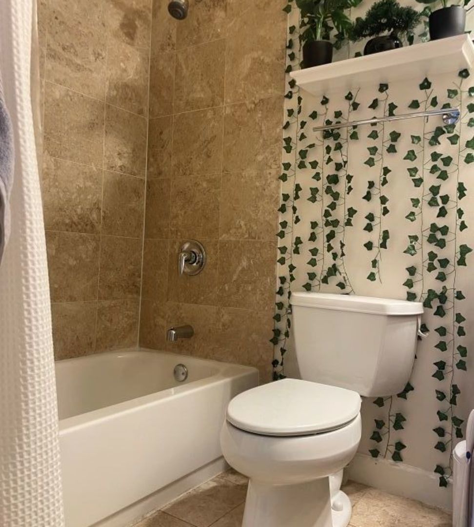 3707 North Kenneth Avenue, Unit 216 Chicago, IL 60641 - Photo 6 of 14 a bathroom with a toilet and a shower curtain
