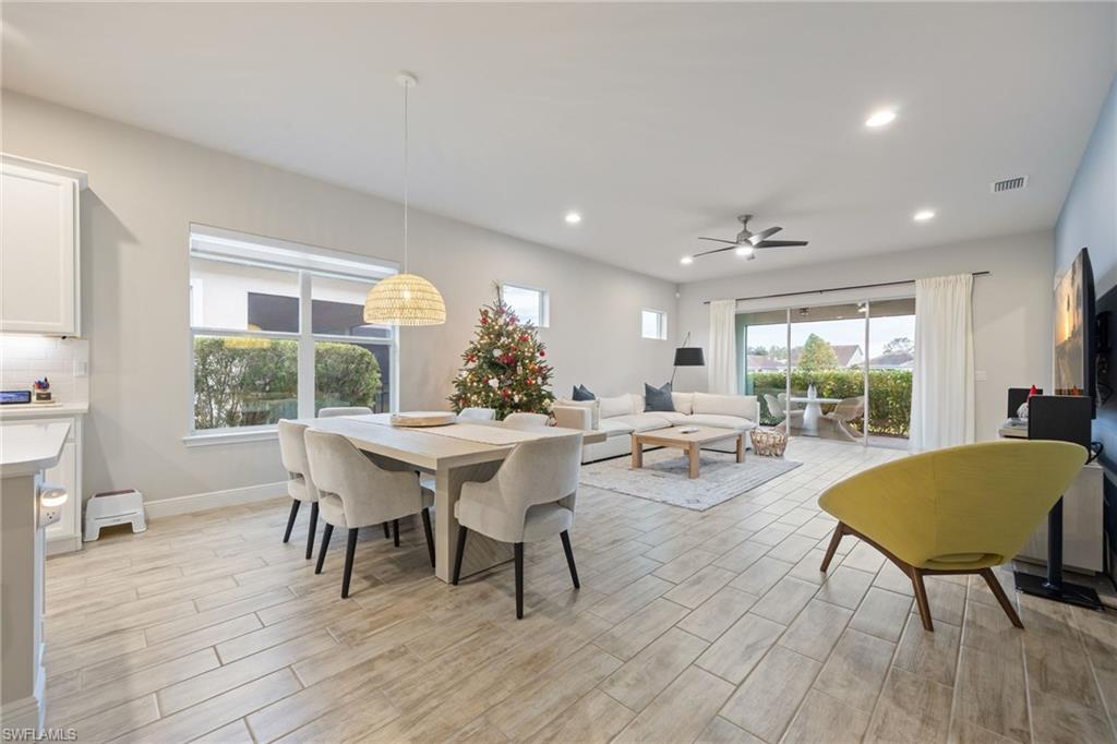3509 Pilot Circle Naples, FL 34120 - Photo 15 of 50 a view of a dining room with furniture and wooden floor