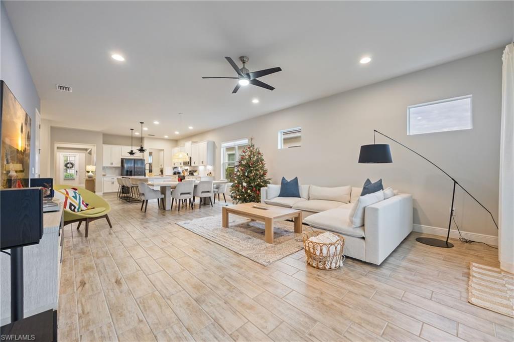 3509 Pilot Circle Naples, FL 34120 - Photo 20 of 50 a living room with furniture and a wooden floor