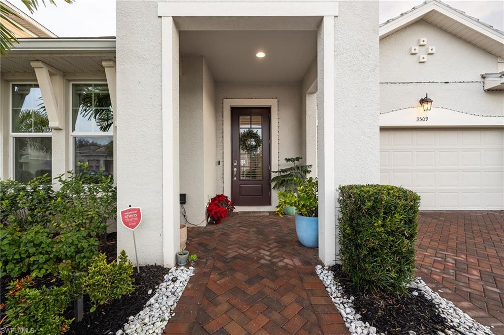 3509 Pilot Circle Naples, FL 34120 - Photo 2 of 50 a view of yellow house with potted plants