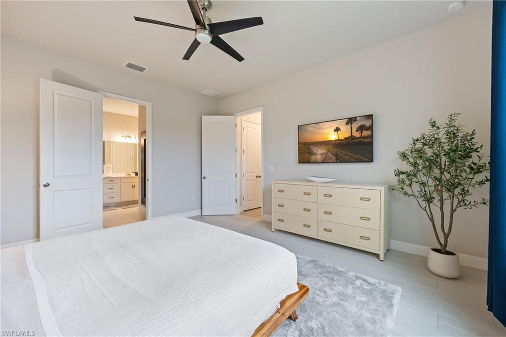 3509 Pilot Circle Naples, FL 34120 - Photo 22 of 50 a bedroom with a bed and a flat tv screen on dresser