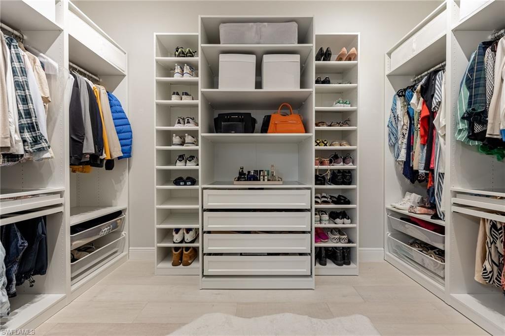3509 Pilot Circle Naples, FL 34120 - Photo 25 of 50 a view of walk in closet with clothes and shoes