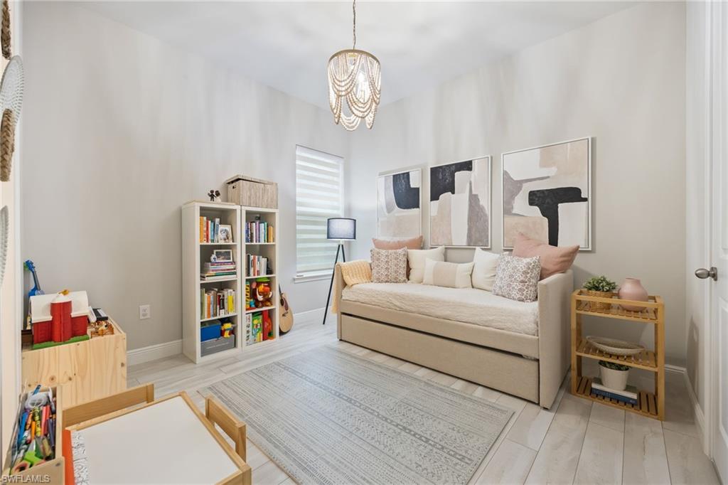 3509 Pilot Circle Naples, FL 34120 - Photo 26 of 50 a living room with furniture and a book shelf