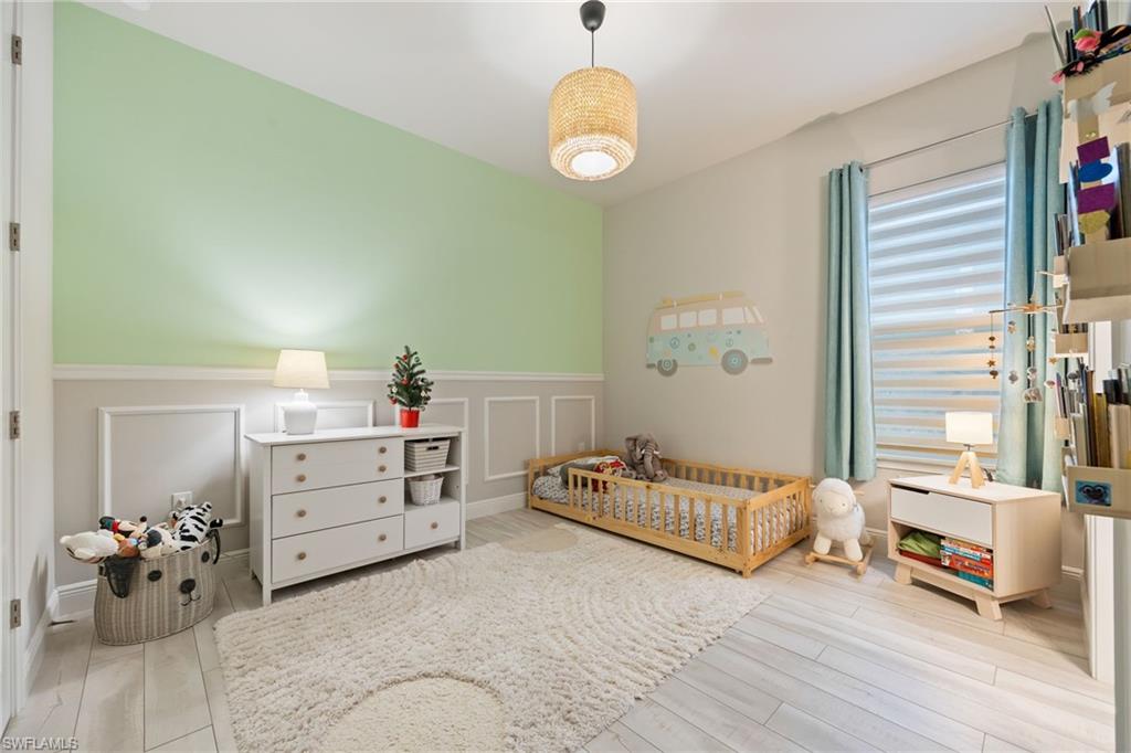 3509 Pilot Circle Naples, FL 34120 - Photo 29 of 50 a bedroom with furniture and a large window