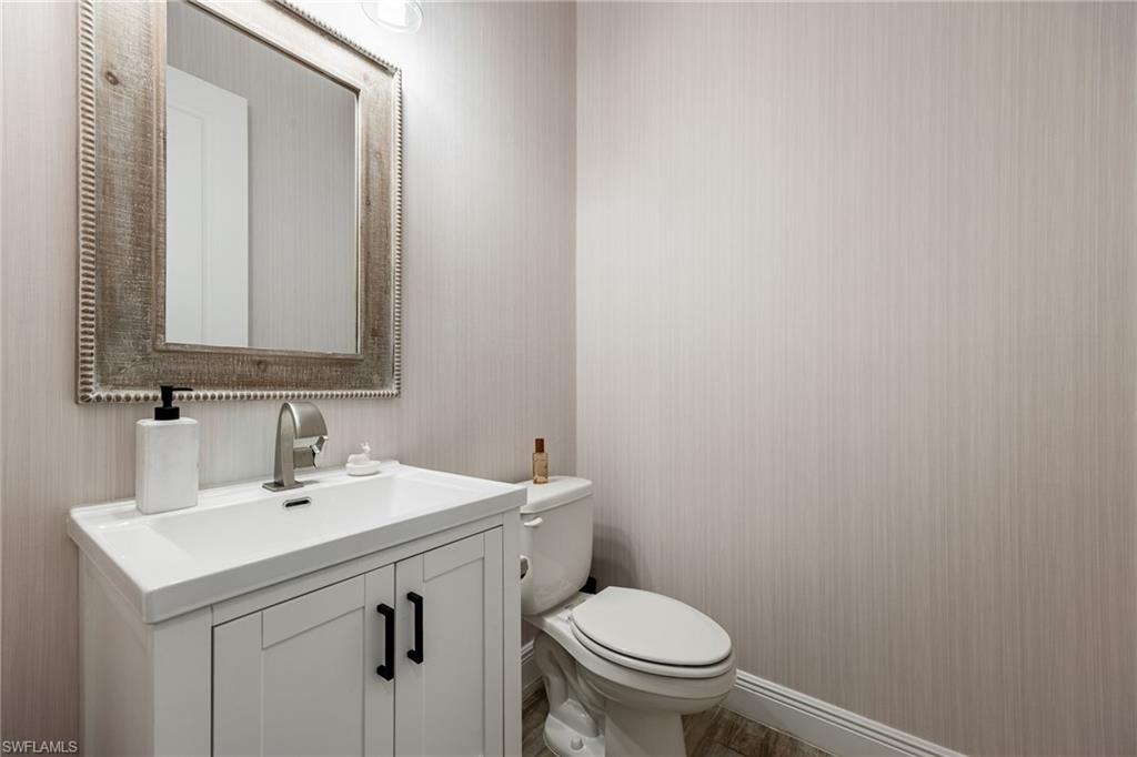3509 Pilot Circle Naples, FL 34120 - Photo 30 of 50 a bathroom with a sink a toilet and mirror