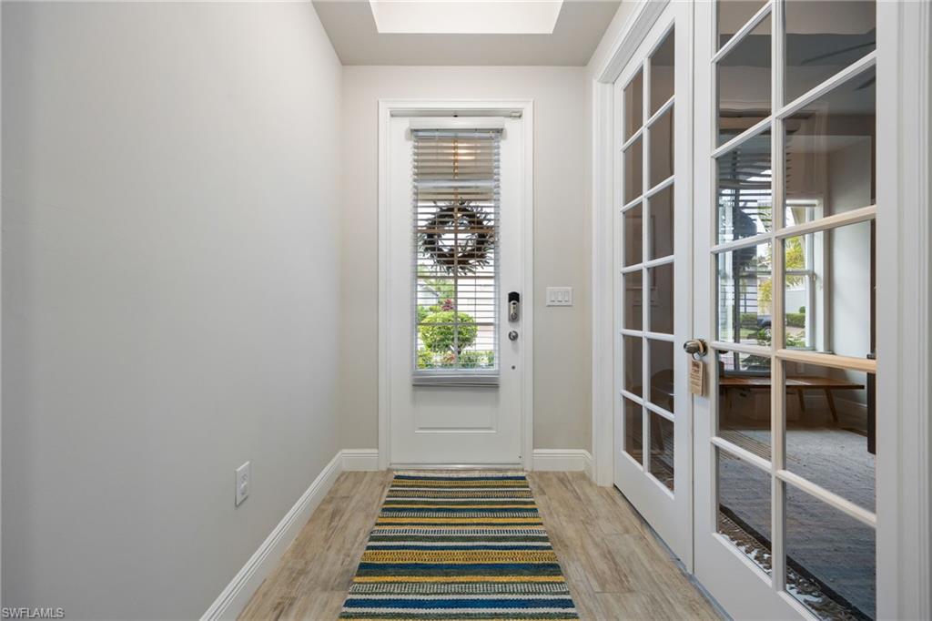 3509 Pilot Circle Naples, FL 34120 - Photo 3 of 50 a view of a hallway with wooden floor and a window