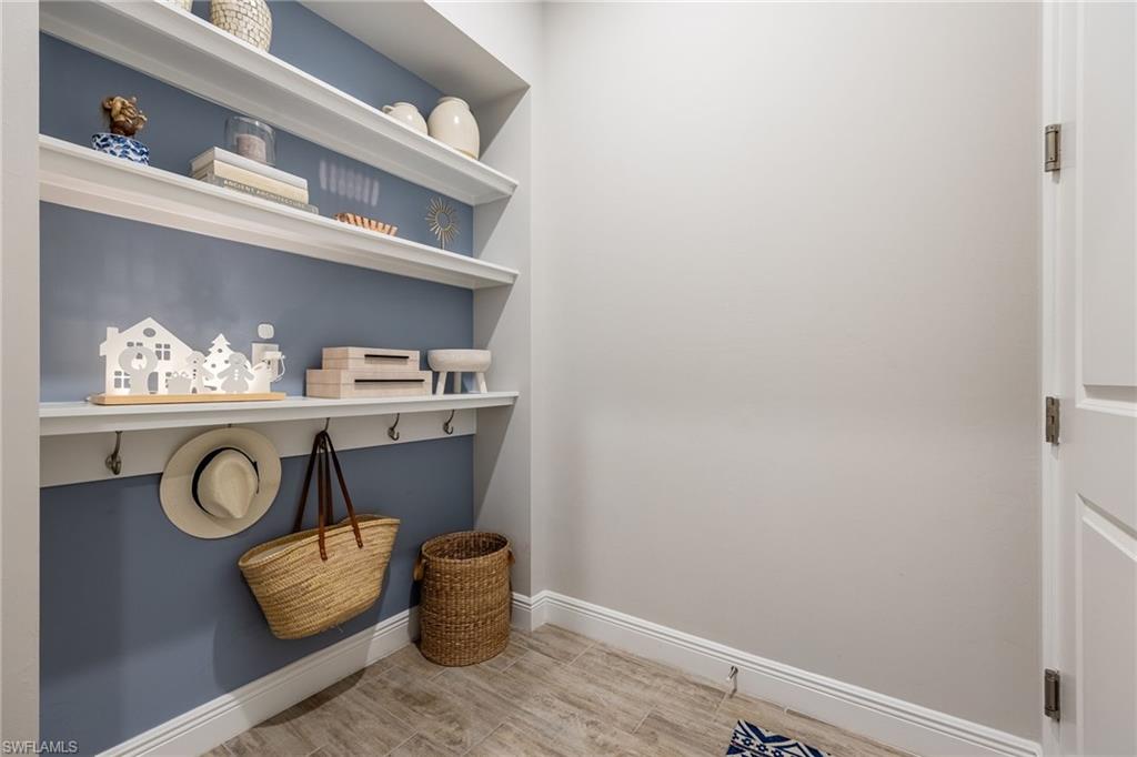3509 Pilot Circle Naples, FL 34120 - Photo 31 of 50 a room with a wooden floor and cabinets