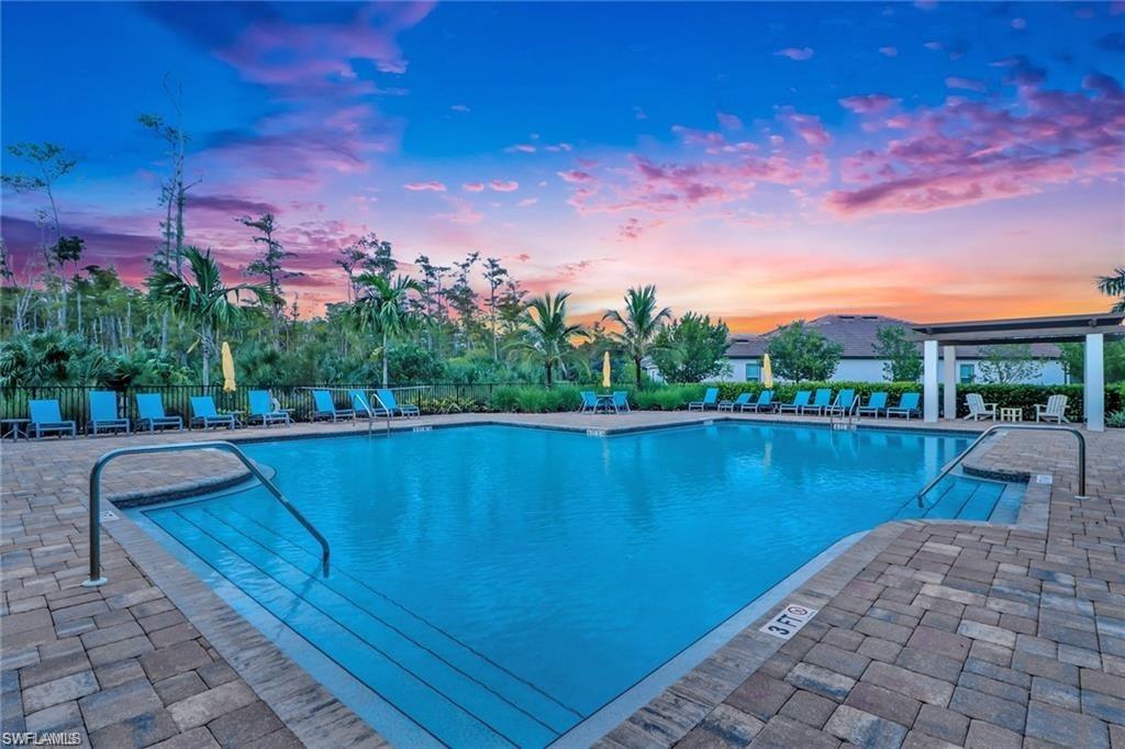 3509 Pilot Circle Naples, FL 34120 - Photo 46 of 50 a view of a lake with a house in the background