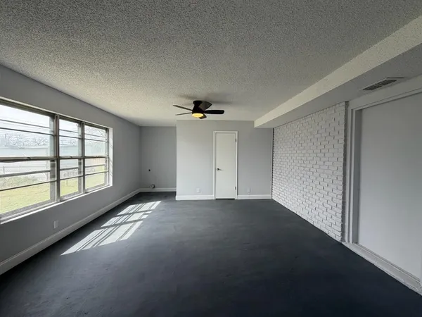 an empty room with a empty space and windows