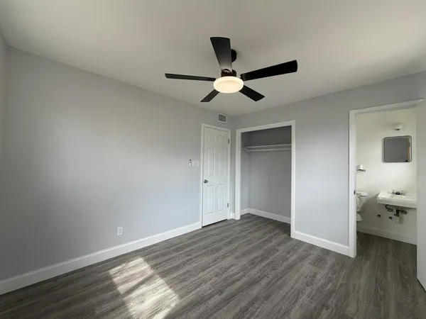 a view of empty room with wooden floor
