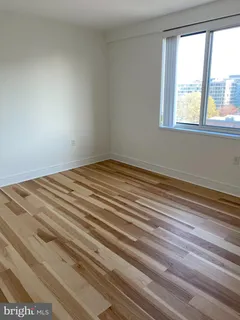 a view of a room that has a bed and a window