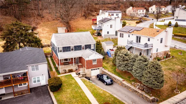 an aerial view of multiple houses with a yard