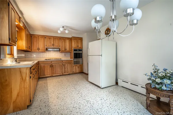 a kitchen with stainless steel appliances granite countertop a sink stove and cabinets