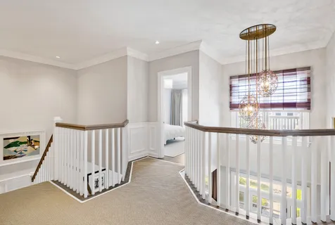 a bedroom with furniture and a chandelier