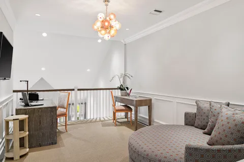 a bedroom with a bed couch and window