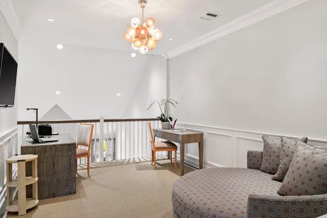 a bedroom with a bed couch and window