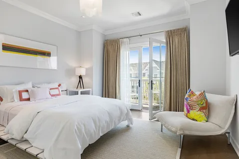 a bedroom with two beds and a large window