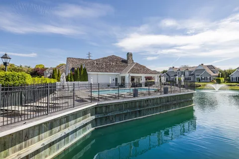 a view of residential houses with outdoor space and lake view