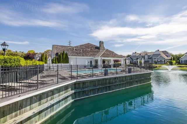 a view of residential houses with outdoor space and lake view