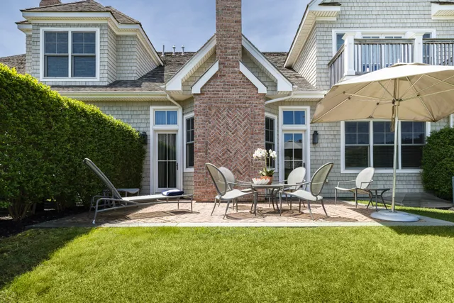 a view of a house with pool and chairs