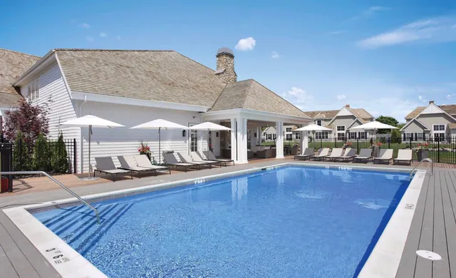 a living room with furniture a fireplace and a floor to ceiling window
