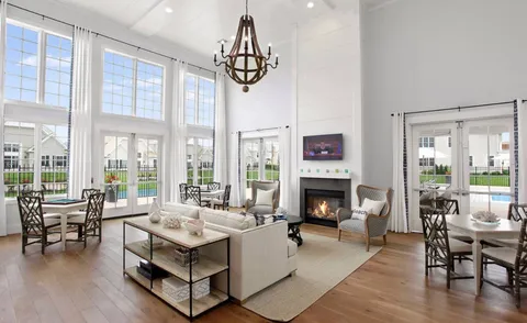 a living room with furniture fireplace and a floor to ceiling window