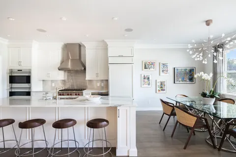 a kitchen with a sink and chairs