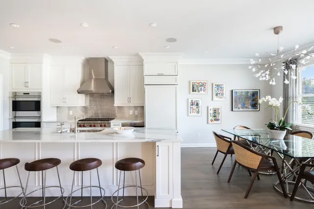 a kitchen with a sink and chairs