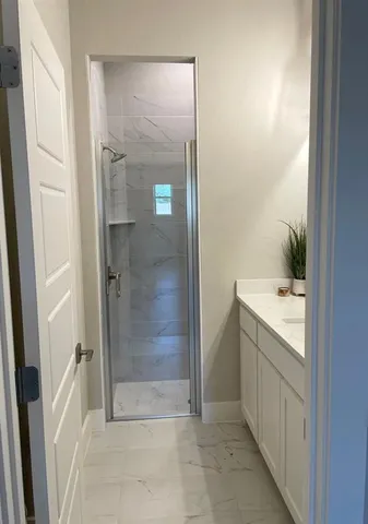 a bathroom with a shower and a sink