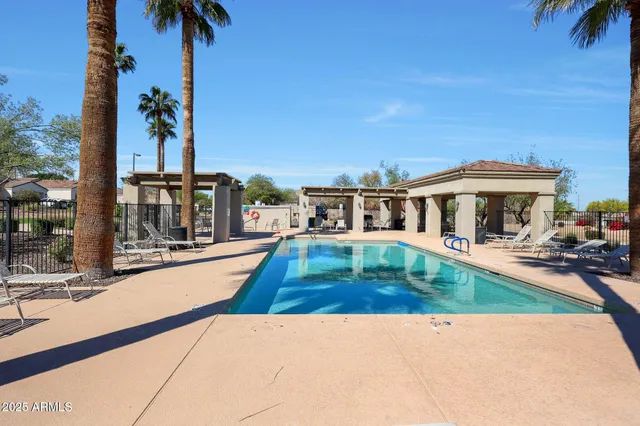 a view of a house with swimming pool and sitting area