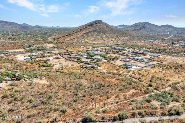 a view of a mountain range with a lush green hillside