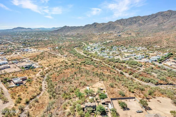 a view of a dry yard with mountains in the background