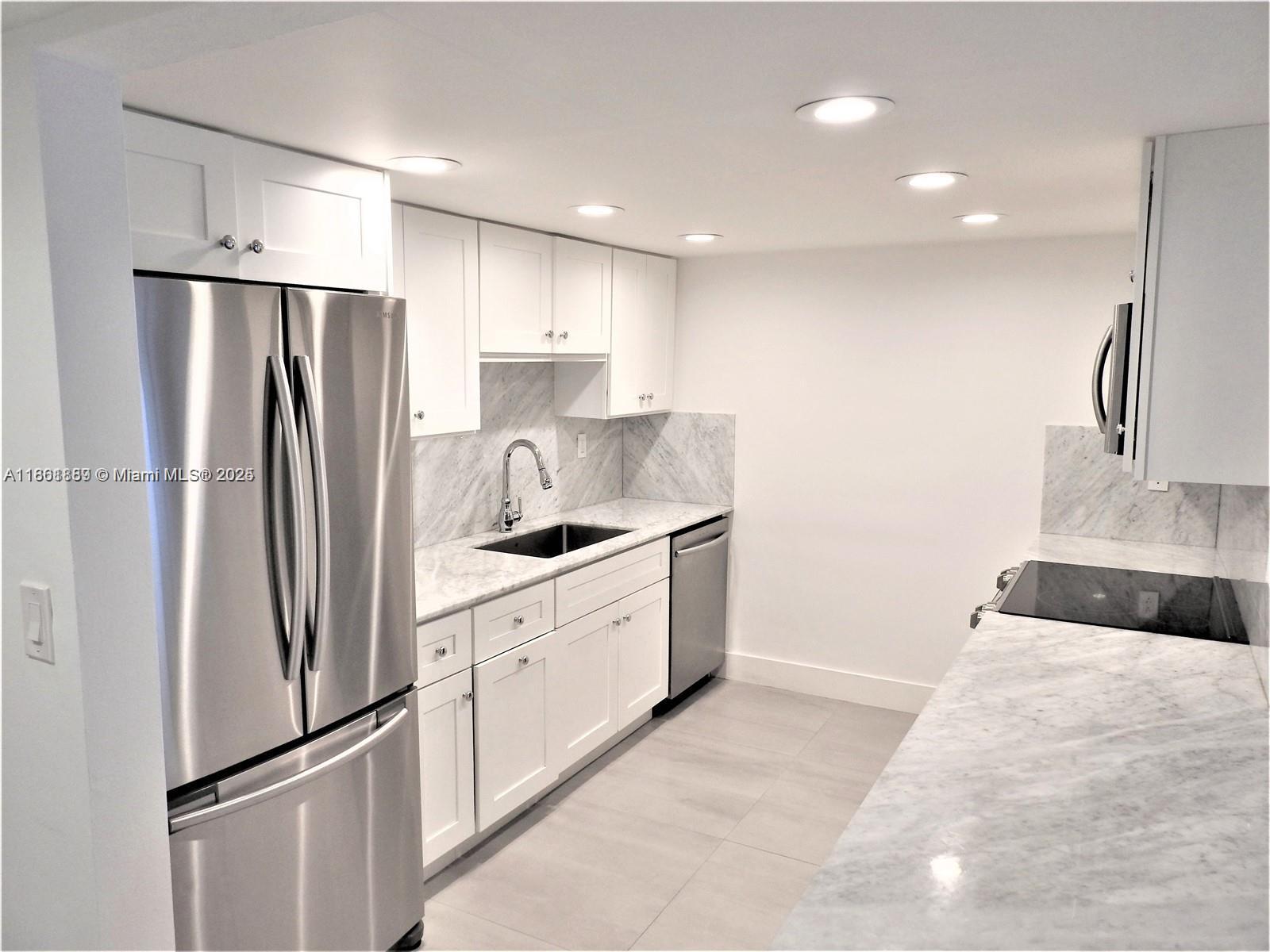 9807 Southwest 93rd Street, Unit 9807 Miami, FL 33176 - Photo 12 of 50 a kitchen with stainless steel appliances granite countertop a refrigerator sink and cabinets
