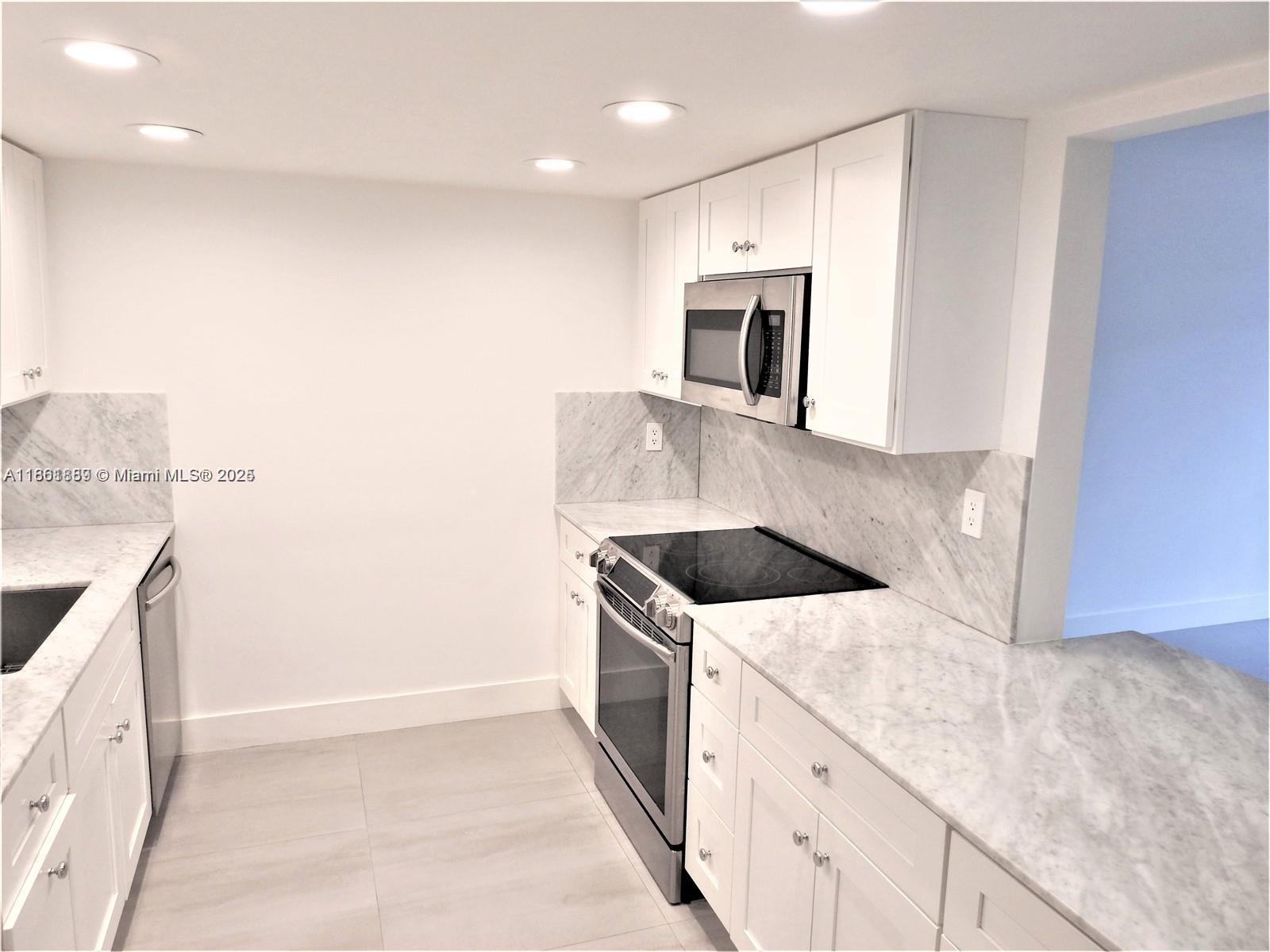 9807 Southwest 93rd Street, Unit 9807 Miami, FL 33176 - Photo 13 of 50 a kitchen with a sink and an oven