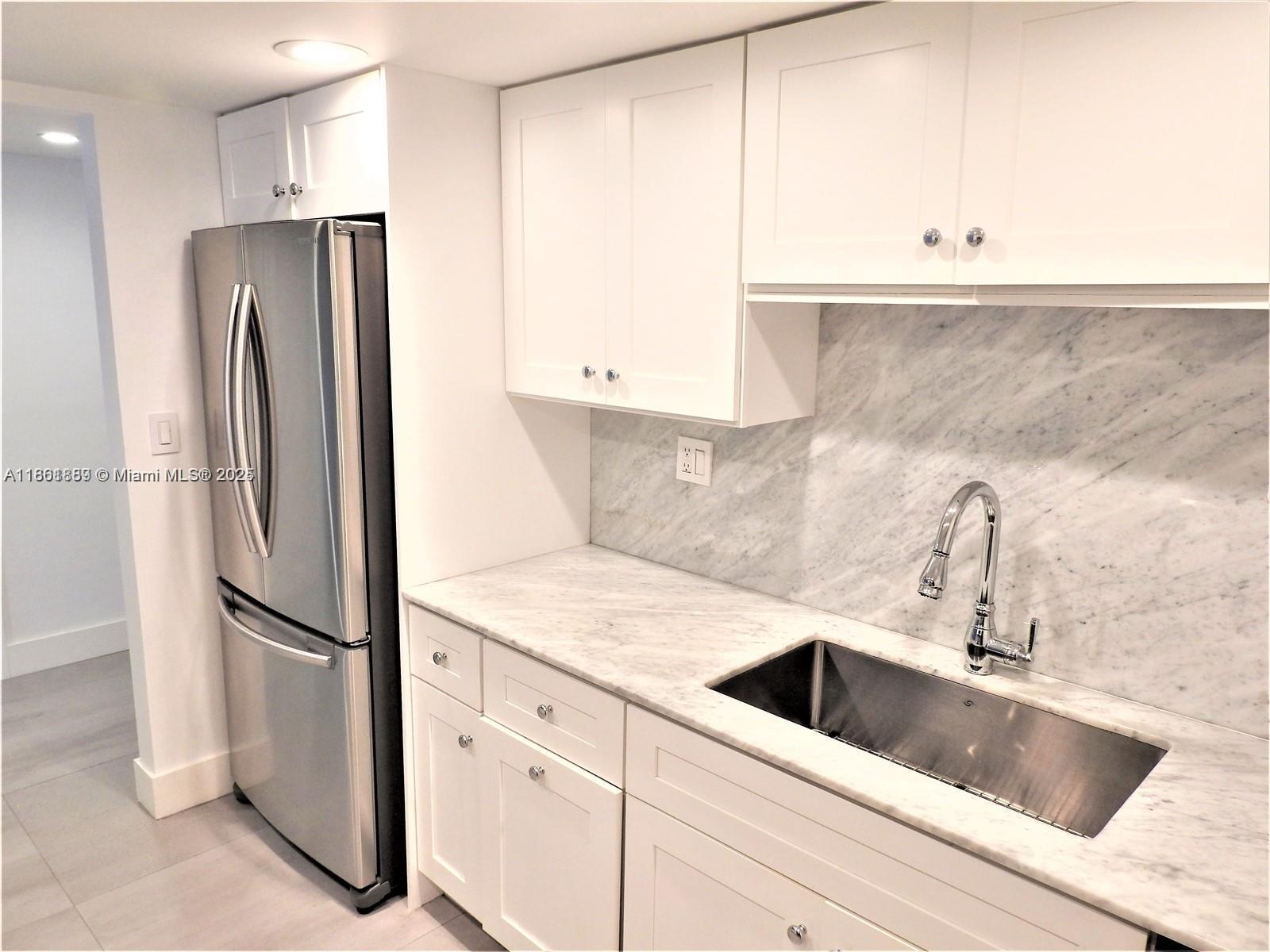 9807 Southwest 93rd Street, Unit 9807 Miami, FL 33176 - Photo 14 of 50 a kitchen with a refrigerator and a sink