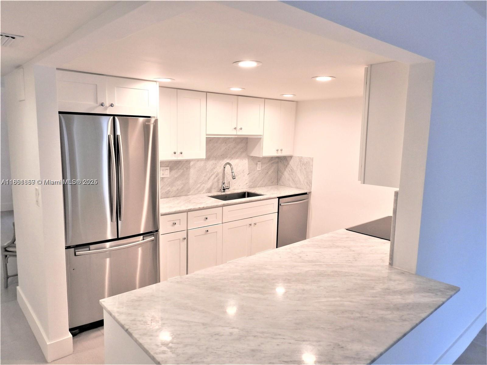 9807 Southwest 93rd Street, Unit 9807 Miami, FL 33176 - Photo 16 of 50 a kitchen with a refrigerator and a sink
