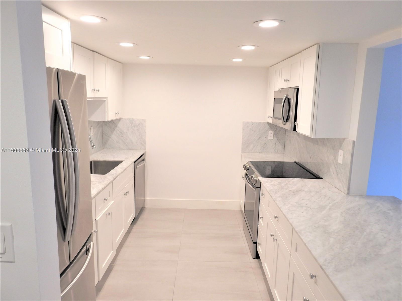 9807 Southwest 93rd Street, Unit 9807 Miami, FL 33176 - Photo 17 of 50 a kitchen with stainless steel appliances granite countertop a refrigerator and a sink