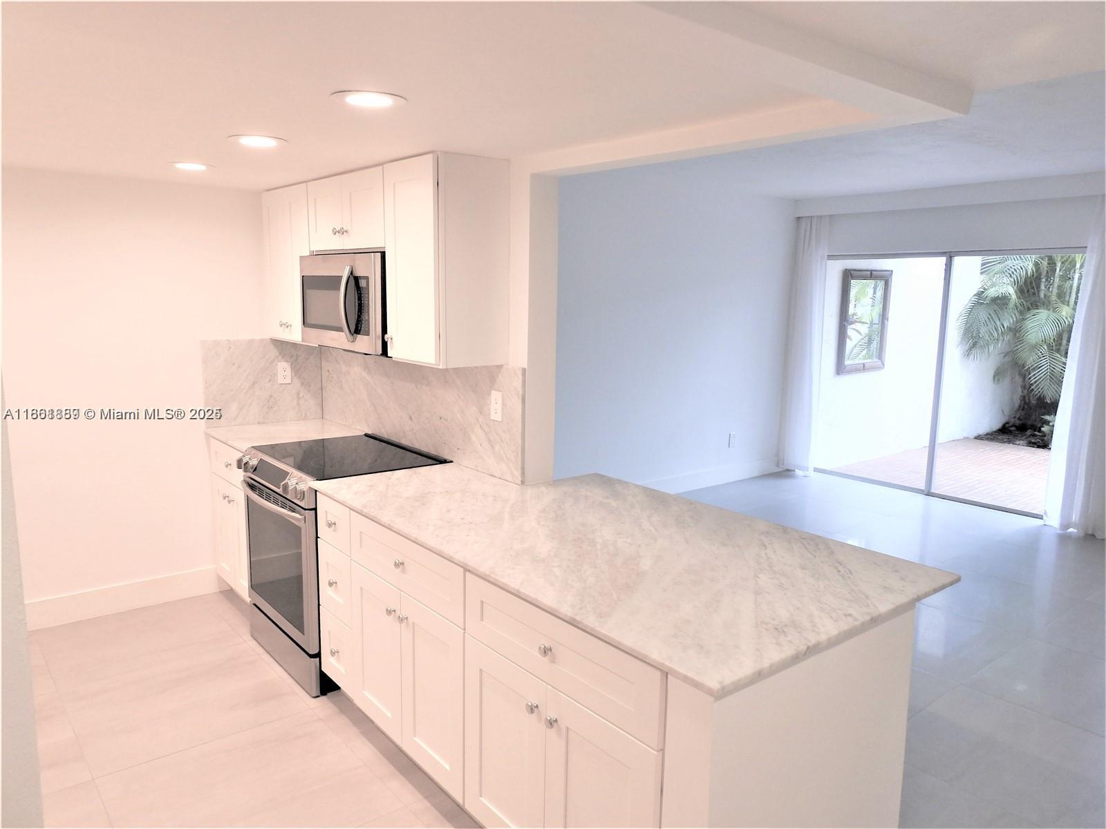 9807 Southwest 93rd Street, Unit 9807 Miami, FL 33176 - Photo 18 of 50 a kitchen that has a sink and a stove